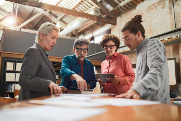 istock Senior designer conducting a meeting in an architecture office. 1188382783