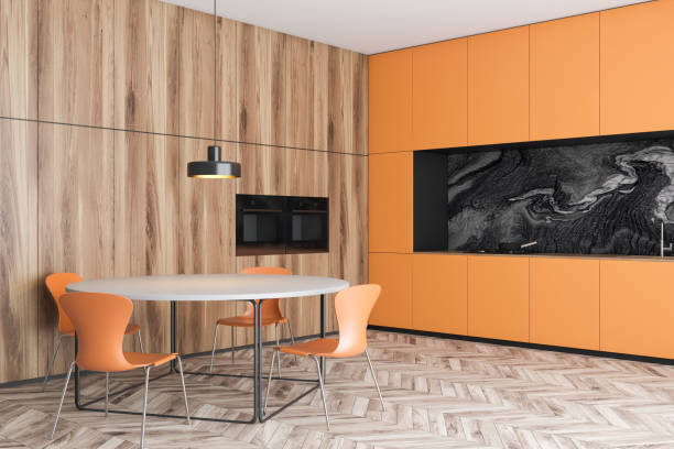 istock Orange and wooden kitchen corner with table 1188382893