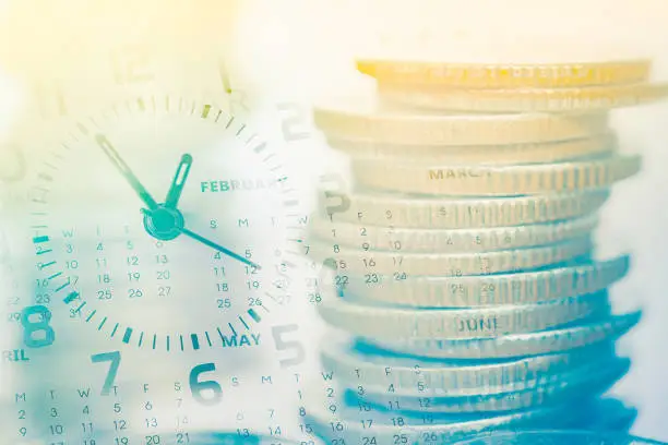 Photo of double exposure of coins and clock with calendar for business and finance background