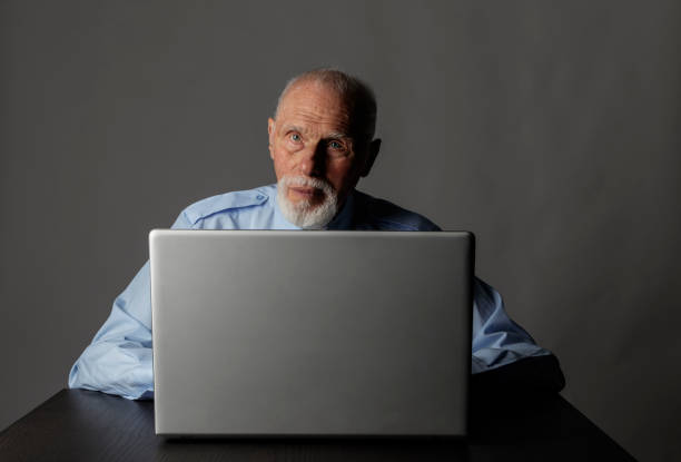 istock Old man is using a laptop to browse the net. 1188384335