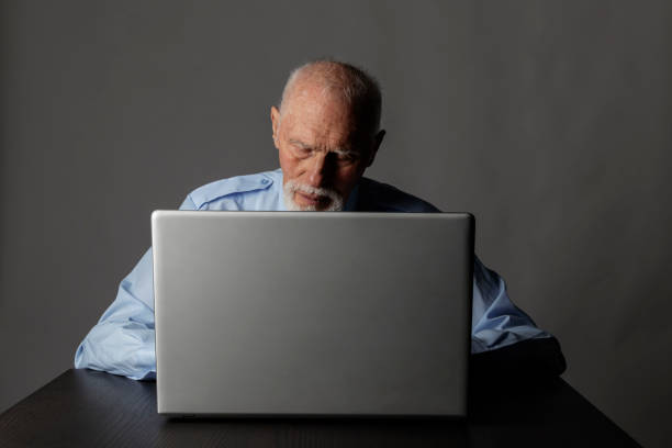 istock Old man is using a laptop to browse the net. 1188384349