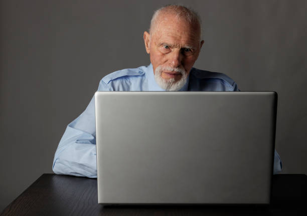 istock Old man is using a laptop to browse the net. 1188384351