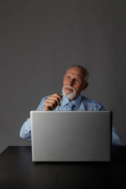istock Old man is using a laptop to browse the net. 1188384368