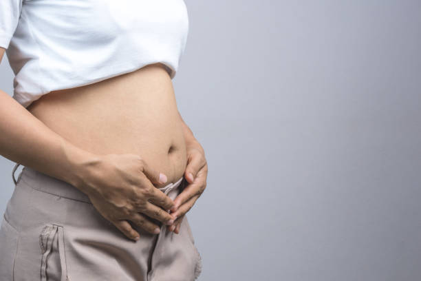 istock Woman touching her fat belly 1188384421