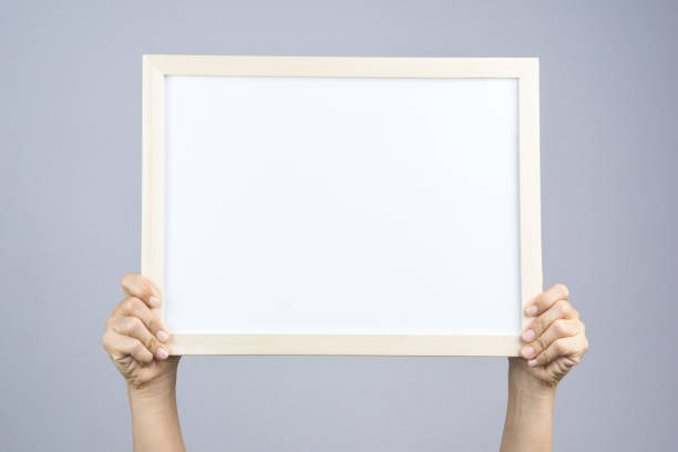 istock Woman hand holding blank wooden frame 1188384439
