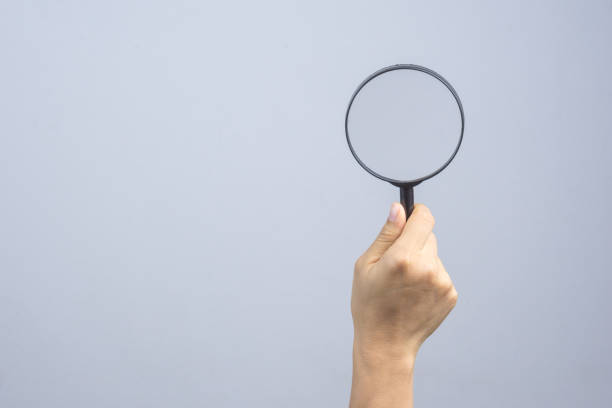 istock Woman hand holding magnifier 1188384617