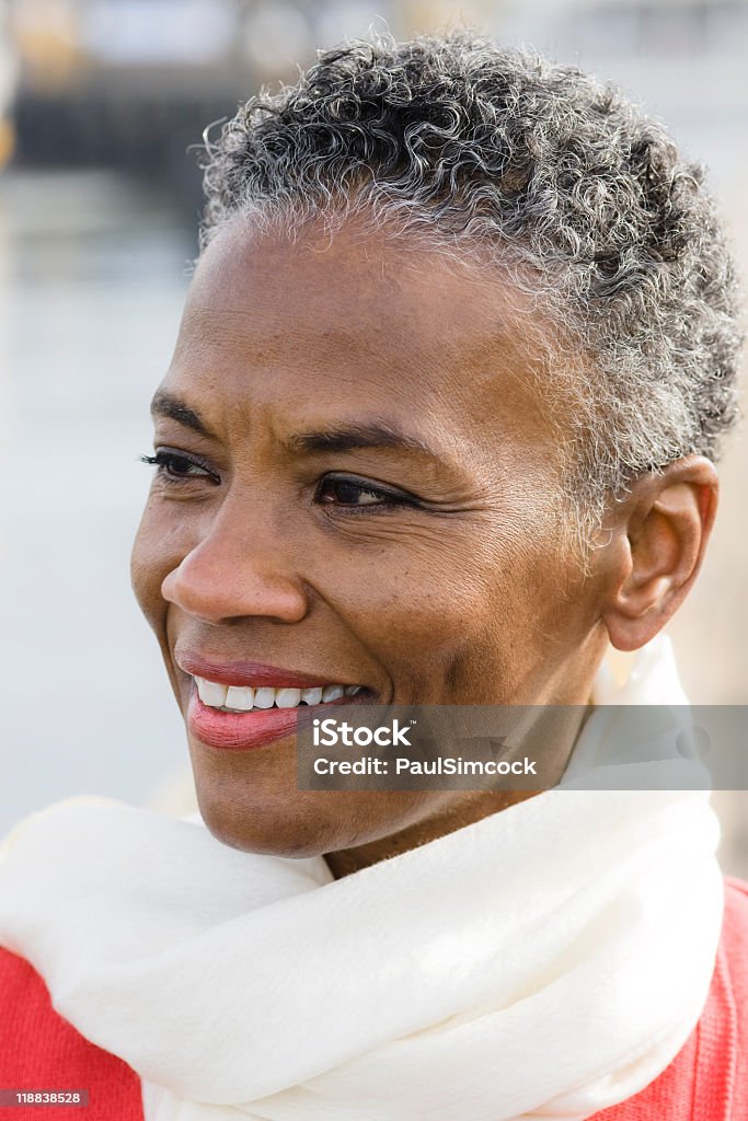 Mature, smiling African American woman wearing white scarf Portrait of a Beautiful African American Woman Gray Hair Stock Photo
