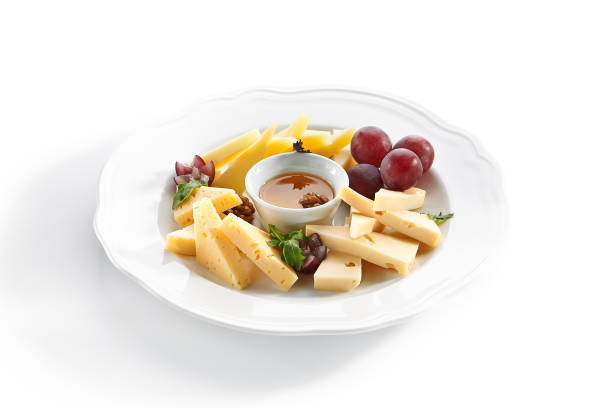 istock Cheese Platter with Honey, Nuts and Grapes on White Restaurant Plate 1188385521