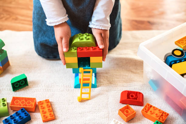 istock Little girl playing with her colorful blocks. 1188385665