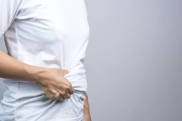 istock Woman touching her fat belly 1188385727