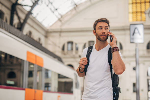 istock Man talking on mobile phone on train station 1188386183