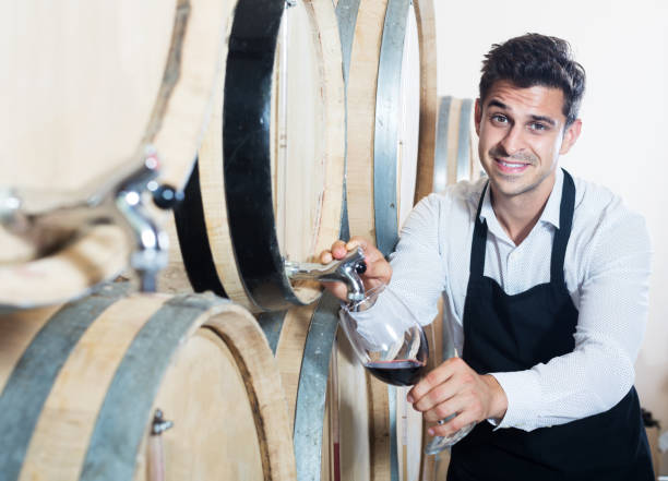 istock Seller pouring wine in cellar 1188387203