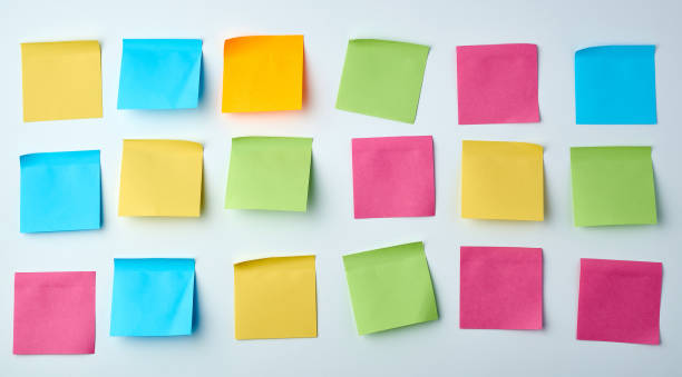 istock three rows of blank square paper multicolored stickers on a white wall 1188388445