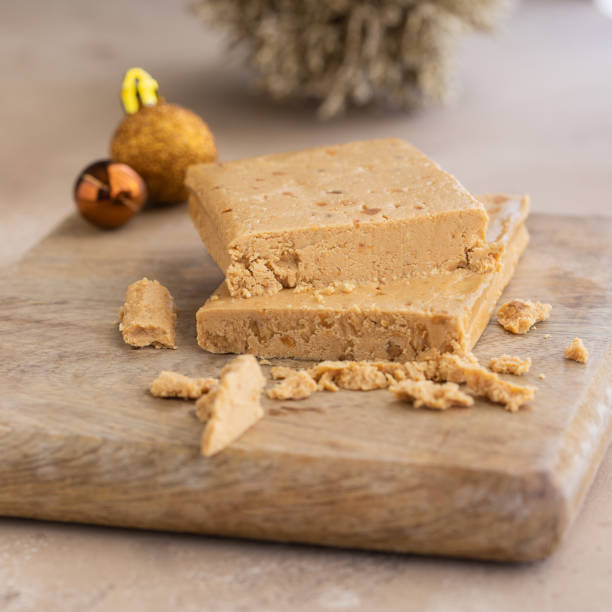 turrón, dulce típico de navidad en españa. turrón de almendras sobre fondo de madera con decoración navideña. - torrone fotografías e imágenes de stock