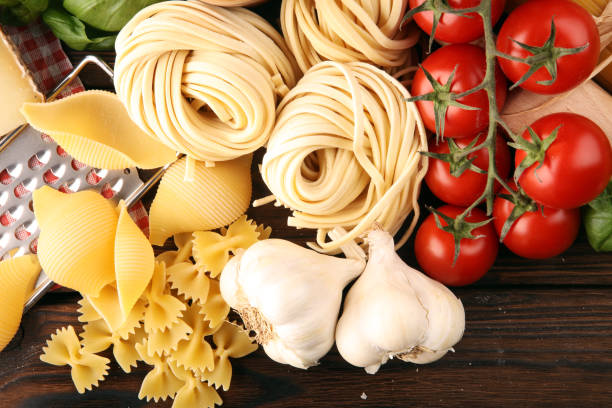 istock Pasta, vegetables, herbs and spices for Italian food on rustic table 1188389357