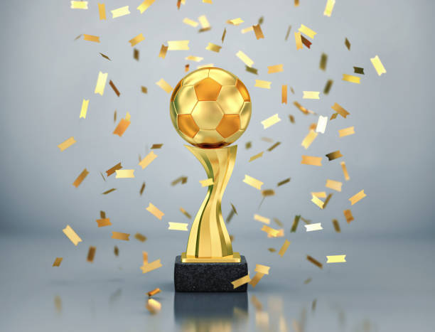 istock Golden ball, soccer winners trophy with falling confetti 1188389396