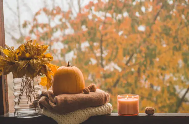 Photo of Still life details in home on a wooden window. Autumn decor on a window