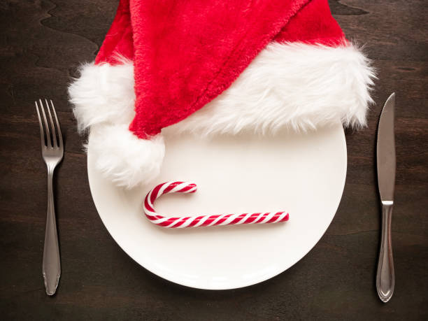 istock White dish with candy cane and santa hat on a tableic 1188395014