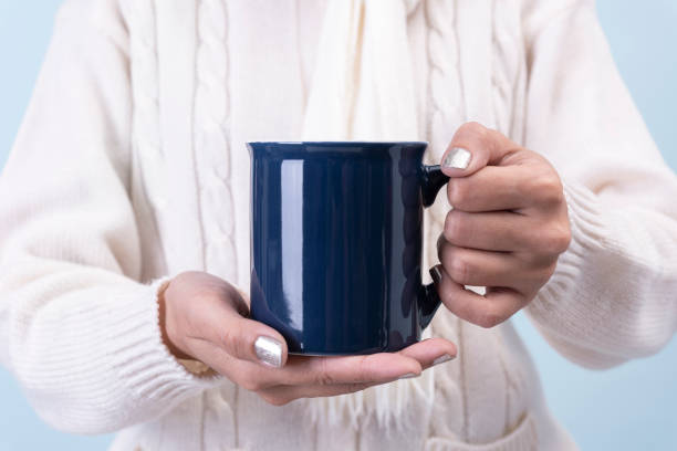 istock women hand holding blue ceramic coffee cup. mockup for creative advertising text message or promotional content. 1188395146