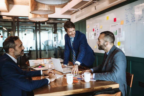 istock Mature formal businessmen in board room 1188395598