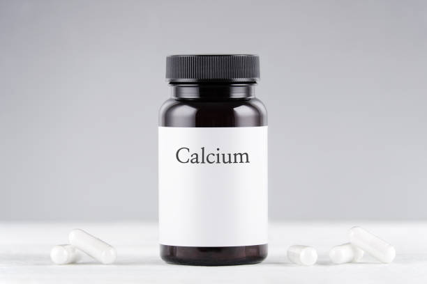 istock nutritional supplement calcium bottle and capsules on gray 1188395751