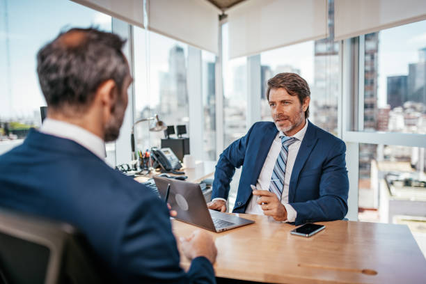 istock Mature businessmen in office discussing about partnership 1188396478