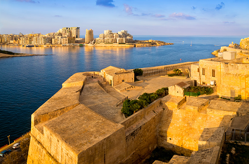 Malta - Mediterranean travel destination, Fortified walls of Valletta and modern residential area in Sliema