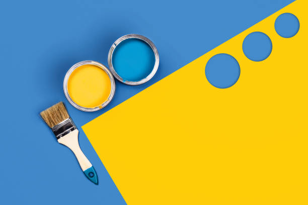 istock Two-toned background with paint jars and brush. 1188398093
