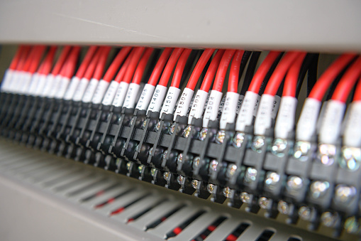 Wiring terminals in the electrical Cabinet. Electrical wires or cables are connected to electrical equipment