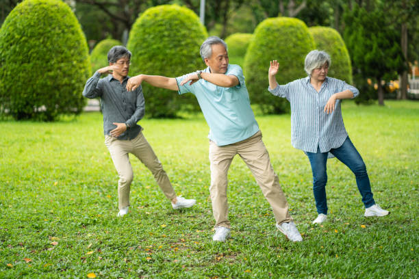 istock Senior friends doing exercises in public park 1188399939