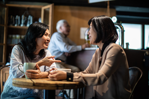 Two Taiwanese mature women having a conversation in cafe