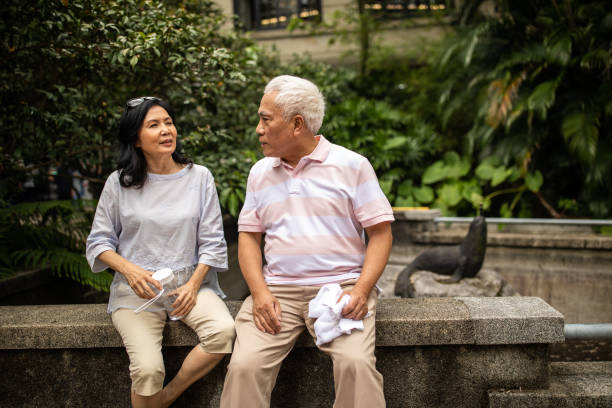 istock Old friends reminiscing about past in public park 1188401071
