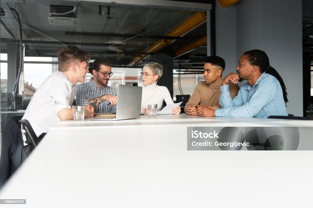 Coworking Young start-up team is working together in coworking space. Adult Stock Photo