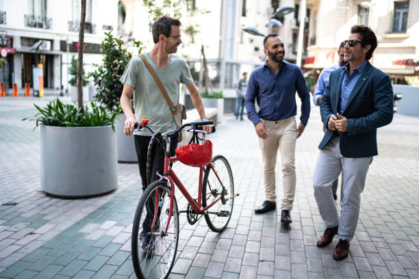 istock Colleagues arriving at work walking and pushing a bike 1188401647