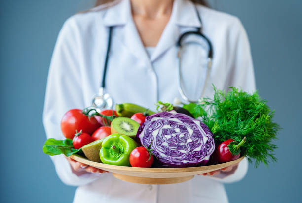 istock Doctor holding fresh fruit and vegetable, Healthy diet 1188401758