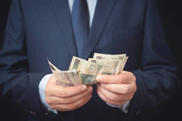 istock Man in a suit counts Polish banknotes 1188401842