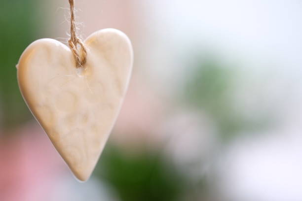 istock Christmas decor ceramic heart, ornament hanging on sacking threads 1188401910