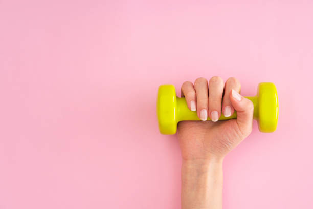 istock Woman holding dumbbell 1188401916
