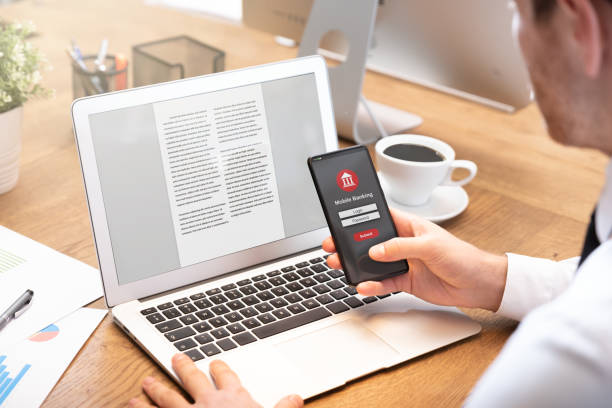 istock Man holding phone with mobile banking content 1188402564