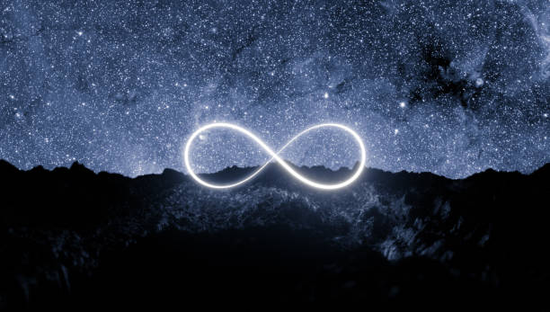 istock Infinite sign neon light on rocky ground monochrome 1188403007