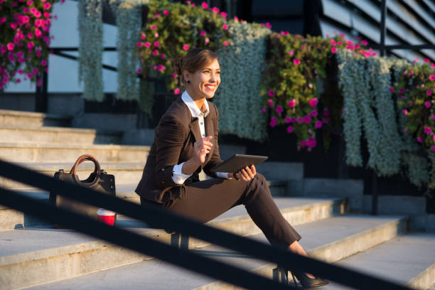 istock Businesswoman using digital tablet on the street 1188403515