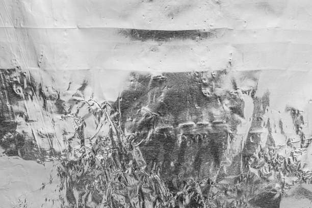 istock Texture of crumpled aluminum kitchen foil. Silver abstract background for design. 1188403684
