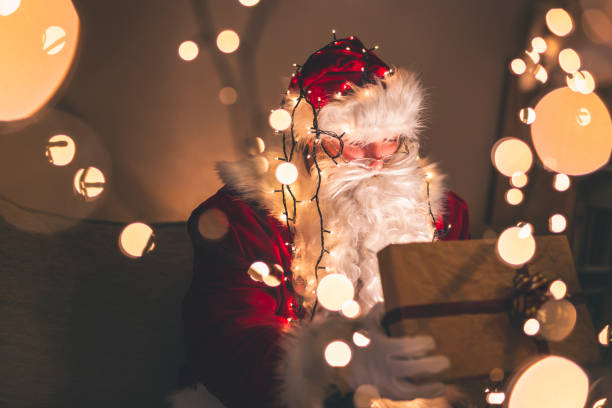 istock Santa Claus opening glowing gift box 1188404938
