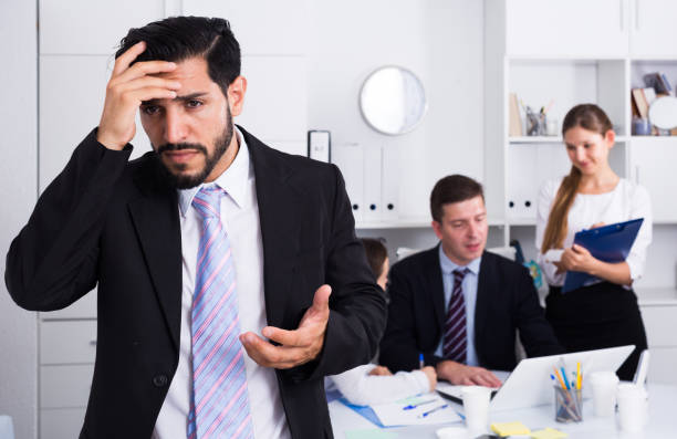 istock Business team with upset man foreground 1188405884