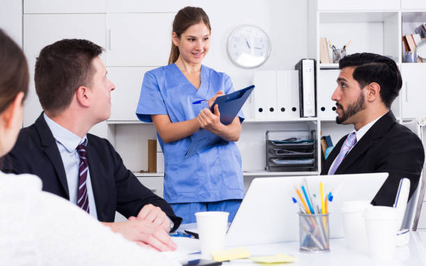 istock Medical worker telling office staff about first aid 1188405893
