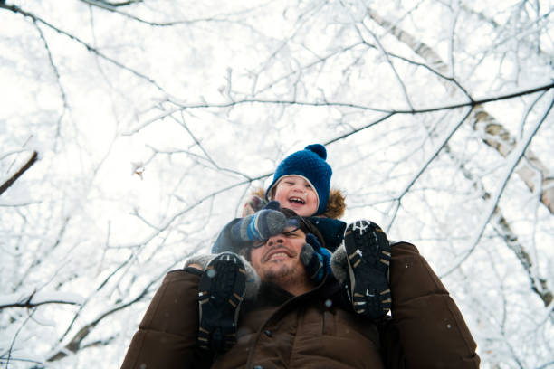 istock Happy family walking in winter forest 1188405942