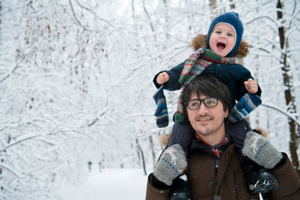 Little boy and father in winter park