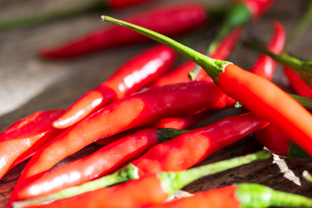 istock Chili hot pepper. Red chili peppers on a wooden rustic table 1188406181