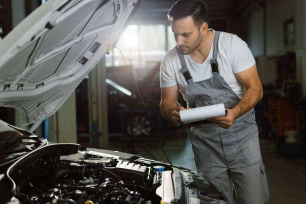 istock Young mechanic going through checklist in auto repair shop 1188406256