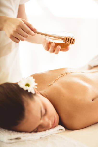 istock Massage therapist applying honey on client's back 1188410922